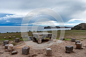 Stone table - sacrificial altar, ruins on the Island of Sun Isla del Sol on Titicaca lake in Bolivia photo