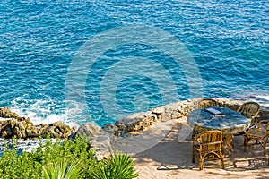 Stone table and wicker chairs