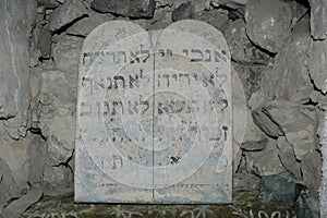 Stone tablet replica of the 10 commandments with faded Hebrew writing that reads: I am the Lord your God, There Shall Not Be, Do