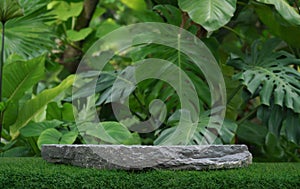 Stone tabletop podium floor in outdoors tropical garden forest blurred green leaf plant nature background.Natural product