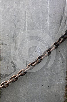 Stone texture with rusty chain for transportation, grunge textured surface of stony material.
