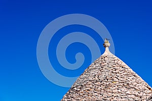 Stone tiles cover the roofs of the trulli in Alberobello, an Italian city to visit on a trip to Italy