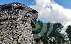 stone tower on a background of sky and trees