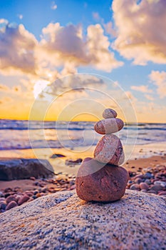 Stone tower on the beach with evening sunset light