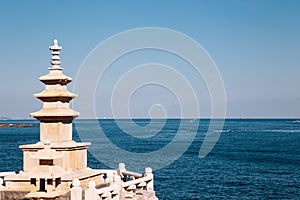 Stone tower with blue ocean at Haedong Yonggungsa Temple in Busan, Korea