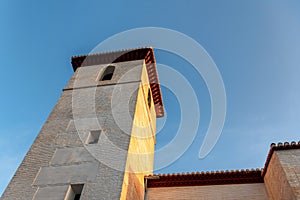 Stone tower at church in Granada, Spain, at sunrise on a clear day