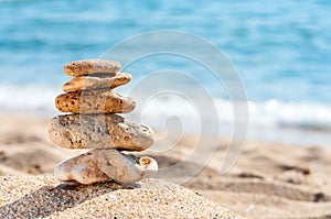 Stone tower in sand against sea.