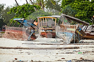 Boats resting on the beach awaiting repairs.