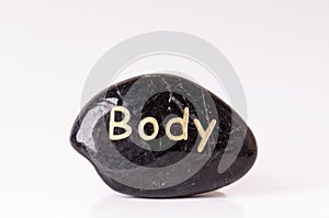 Stone treatment. Black massaging stones on a white background. Hot stones. Balance. Zen like concepts. Basalt stones.