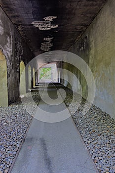 stone tunnel with a path overlooking the park