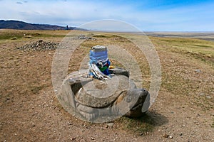 Stone turtle with sacred hadags or khadags blue silk scarves close to Erdene Zuu Khiid Monastery, Kharkhorin, Mongolia