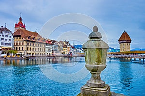 The stone urn on the embankment of Reuss river and view on Altstadt district of Lucerne city, Switzerland