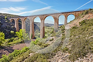 Stone viaduct in Albentosa, Teruel. Spain. Green way.