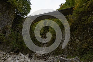 Stone viaduct arch bridge on railway through forest