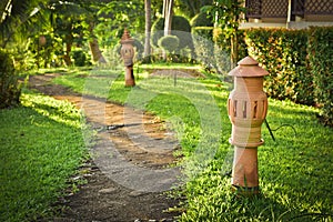 Stone walkway and earthenware lamp street in the resort garden w