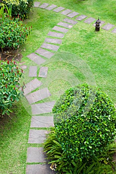 Stone walkway in the park with green grass