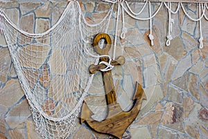 Stone wall with anchor and rope net decor