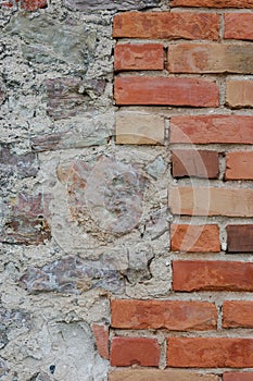 Stone wall background closeup, vertical plastered grunge red brick stonewall, beige limestone pattern, old aged weathered beige