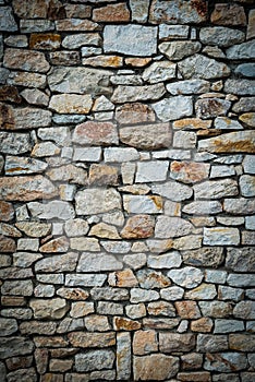 Stone wall background. Vignetted borders. Vertical photo photo