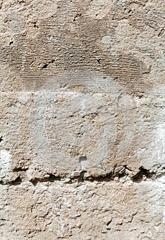Stone wall background. Organic surface, a fragment of an old wall with damages. Grunge texture close up.
