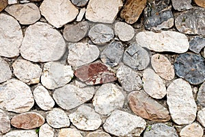 Stone wall background of various elements of different shapes and cut