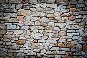 Stone wall background with vignetted borders photo