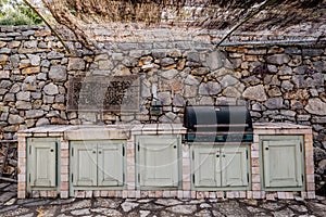 Stone wall, barbecue and cupboards outdoor, garden yard relaxing space