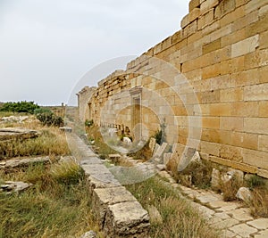 Stone wall and blocks at ancient Roman ruins of Leptis Magna on Libya`s Mediterranean coast
