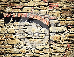 Stone wall with brick arch