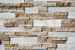 Stone wall brick texture background beige and white surface facade. Close - up