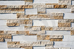 Stone wall brick texture background beige and white surface facade. Close - up.