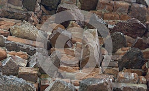 Stone wall. Bricks and stones on the ruins of an old building. Close-up