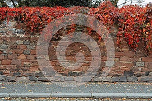 Stone wall and cobblestone sidewalk