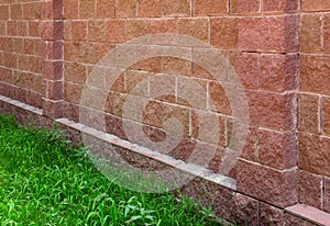 Stone wall with column and green grass