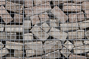 Stone wall of concrete bricks and mesh