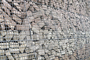 Stone wall of concrete bricks and mesh