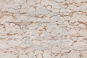 Stone wall with cracks and fissures