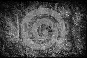 A stone in a wall with the date 1929, black and white colored