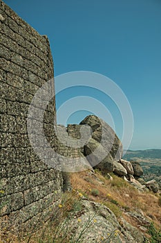 Stone wall on hilltop covered by rocks at the Castle of Monsanto
