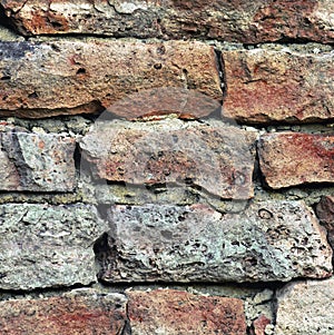 Stone wall macro closeup, stonewall pattern background, old aged weathered red and grey grunge limestone dolomite