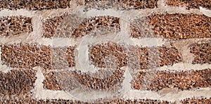 Stone wall made of bricks with wide gray joints, stripes close-up