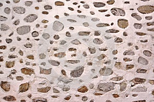 Stone Wall Made From Granite Rocks With White Honeycomb Pattern