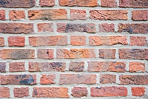 Stone wall with much brown bricks of the modern building