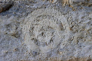 Stone wall with a multilayered old tumbling whitewash texture