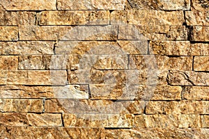 Stone wall of natural stones in different sizes. The facade of the house.