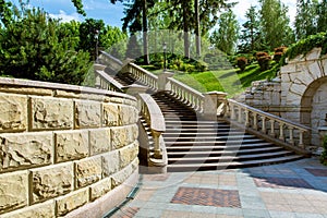 Stone wall near the marble staircase with balustrades.