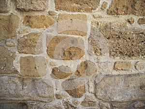 Stone wall of the old building, sand color, stone background.