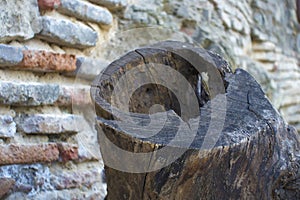 Stone wall and piece of tree trunk