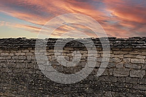 Stone wall and pink sky background