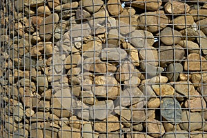 Stone wall reinforced with metal mesh.